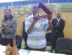 Prime Minister Bernard Makuza holds up a gift he received from Kigali City Council yesterday at Petit Stade, Remera. (Photo/ O. Mutarayire).