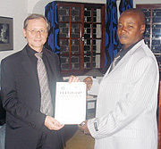 Electrogaz Coach Abdul Mbarushimana receiving the Class A Coaching Certificate from Germanyu2019s Acting head of mission Wolfgang Niersbach.