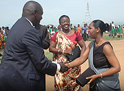 Chief Justice Aloysia Cyanzayire greets Nyagatare District Mayor Robert Kashemeza on arrival at the Womenu2019s day celebrations, as Gender Minister Jeanne du2019Arc Mujawamariya looks on. (Photo/ J Mbanda)