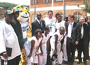 Sports Minister Joseph Habineza and former Bafana Bafana star Mark Fish (M) enjoy a photo shoot at Kimissagar Youth Centre after the  2010 World Cup Official Mascot was unveiled in Kigali last weekend. (Photo / P. Bakomere)