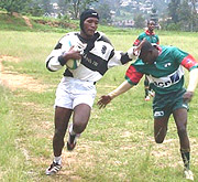 UNR Grizzlies Koko Cambara hands off a Buffalo player before scoring a try at this yearu2019s Buffalo 7s rugby tourney. (Courtesy photo).