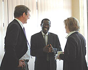 Director of OGMR Micheal Biryabarema (C)chattting with John Cole-Baker and Dr Gudrun Franken after the opening of the workshop on Friday. (Photo/ G.Barya)