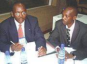 The Counsel to the Community, Wilbert Kaahwa (L) talks to Cyrus Nkusi, the Director of the Rwanda Youth Network (RYN) at the Kenyatta International Conference Centre on Friday. (Photo/ G. Muramira).