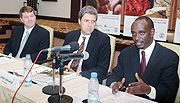 Health Minister Dr Richard Sezibera (R) responds to reportersu2019 questions as Doctors Julian Lob-Levyt (C) and Orin Levine look on. (Photo J Mbanda)