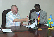 Thomas Bedenbecker of GTZ and Anastase Kimonyo, the Director General of the RBS sign the MoU.