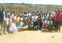 Sylvestre Nzitukuze (extreme Left) founder of the orphanage, Celestin Mitabu the Director (extreme Right) pose for a photo with some of the orphans (Photo G.Mugoya)