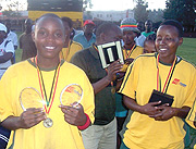 Angelique Nzabanita (L) displays her MVP and Top Scorer awards in the Kyadondo 7s in Kampala in 2006 as teammates look on. (File photo).