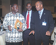 Defence PS Amb. Zac Nsenga (L) and RCSS Executive Secretary Lt. Col. Joseph Nzabamwita listen to ACSS chair of Defence Economics Dr. Assis Malaquias at Serena Kigali Hotel.