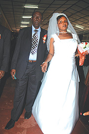 85-year-old Simon Gatsinzi and his bride Grace Rwagitare walk down the aisle on Saturday