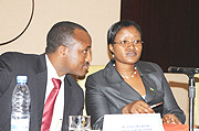 Monique Mukaruliza, Rwandau2019s Minister of EAC being consulted by Alloys Mutabingwa, the Deputy Secretary General (Infrastructure and Planning) EAC. (Photo G Barya).