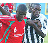 Kabange Twite (R) tries to fight for the ball with a Muzinga player. He scored APRu2019s third. (Photo G. Barya).