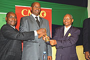 Minister of Finance James Musoni shares a light moment with CMACu2019s board chairman Henry Gaperi (L) and KCB group chairman Peter Muthoka (R) yesterday.