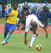 Elias Uzamukunda (L) beats a Malian opponents during the AYC held in Kigali early this year.  The striker is expected to travel to France for a medical at his new club FC Nantes.