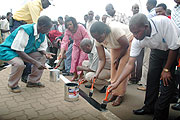  Kigali City Mayor Aisa Kirabo (2nd right) joins in the re painting of roads in preparation of the 15th aniversary of Liberation. (Photo J Mbanda)