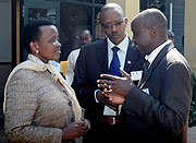 Acting Commissioner  General of Police Mary Gahonzire (L) talks to Assistant commissioners of Police Joel Ndahiro (C) and JMV Nshimiyimana during the Regional meeting on the Programme of action on small arms and light weapons at Serena Hotel. (Photo J Mba