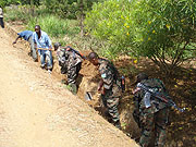 Some of the soldiers putting finishing touches to the road moments before its commissioning. (Photo: D. Sabiiti)