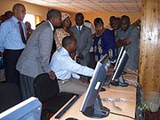 Dr. Kilemi (center) in the company of Gicumbi Court and ICTR officials tour the Courtu2019s information and documentation center.