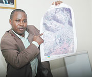 National land centre Director General Emmanuel Nkurunziza displays aerial pictures during the Press Conference. (Photo J Mbanda)