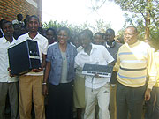 Former Rwandan ambassador to New york, Joseph Nsengimana (R),Clare Effiong Director Esters Aid (3rd R) with students as they display some  of the donated computers.