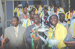 Col (Rtd) Ludovic Twahirwa (Dodo), the Atraco club president (L) with the victors at the airport yesterday (Photo J Mbanda)