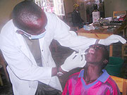 Lieutenant Pierre Claver Mazimpaka treating a patient.