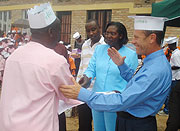 Kevin Jones, president of Criminon Africa, and Chantal Uwantege(C) , the director of Gitarama prison award certficates to inmates who  had completed rehabilitation training. (File photo).