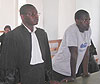 Muhawenimana seeks for justice in the company of his defense lawyer in Musanze court room. (Photo: B. Mukombozi)