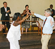 British politician Andrew Michell joins one of the teachers in a dance.   (photo;F. Goodman)