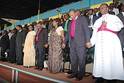 Religious leaders join hands in Prayer during the convention at Amahoro stadium. (Photo J Mbanda)