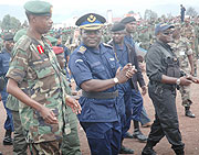 Generals Kabarebe and Numbi walk through a procession of RDF and FARDC troops during the event to mark the end of  operation  UMOJA WETU. (File photo)