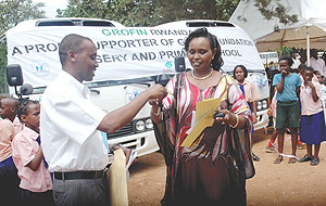 Grofin Country Manager  Eric Rwigamba hands over the Busesu2019 keys and log books to  the Principal of Good foundation School, Aurelie Umutoni, yesterday. (Photo/ J. Mbanda)