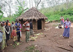 IN SHOCK: Residents gather at the late Gatosou2019s home after the incident. (Photo/D. Ngabonziza)