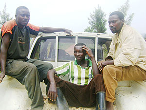 Eugene Habiyaremye (seated in middle) being driven to the police station following his arrest by community policing agents. (Photo: S. Rwembeho)