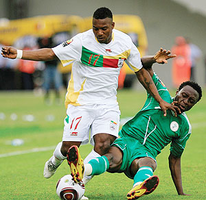 Obasi Ogbuke (R) of Nigeria vies for the ball with Ogunbiyi Mouritala of Benin during their group