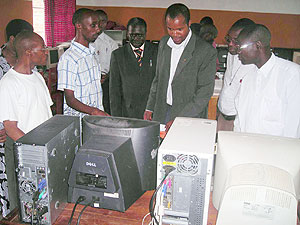 Teachers try out the new computers. (Photo: B. Mukombozi)