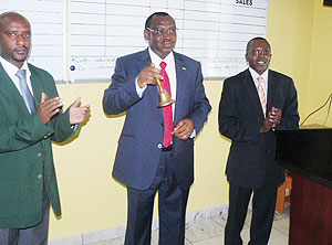 Ambassador Claver Gatete (Centre) rings the bell to mark commencement of business on the ROTC market (Photo J. Gahamanyi)