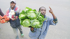 A vegetable seller on a Burundi highway gesticulates with a customer aboard a bus. Such informal business people will make use of Swahili in transactions with other East Africans (Photo/ Kelvin Odoobo)