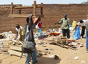 Remera Taxi Park vendors collecting some of their property after their stalls were demolished yesterday. (Photo/ F.Kanyesigye)