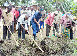 LEADING BY EXAMPLE: Karongi Mayor Bernard Kayumba (centre) leading residents in the community work to fix the Karongi-Rubavu road. (Photo: S. Nkurunziza)