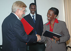 German Ambassador to Rwanda Elmar Timpe (L) and Rwandan Foreign Minister Louise Mushikiwabo shake hands after signing the agreements yesterday. (Photo J Mbanda)