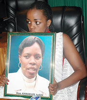 One of the late Kanakuzeu2019s daughters holding her  portrait yesterday. (Photo J Mbanda)