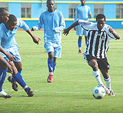 APRu2019s midfielder Haruna Niyonzima takes on Rayon Sport defenders during their league meeting a fortnight ago. The league resumes this afternoon when APR take on Marines in Gisenyi. (File photo)