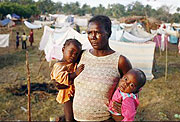 A mother and her children are forced to sleeping in makeshift shelters