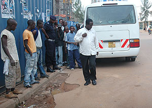 The aftermath of the grenade attack. Onlookers at the sight of the Rubangura attack, Police Spokesman, Supt Eric Kayiranga (left).