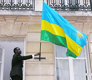 First Counsellor, Olivier Kayumba, Hoists the national flag at the offices of the newly reopened Embassy in Paris yesterday (Courtesy photo)