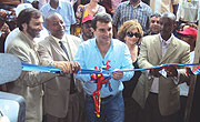 FC Barcelona President Joan Laporta and other officials cutting a ribbon at the opening of a multi-purpose hall at Kixiba camp yesterday. (Photo/ S. Nkurunziza)