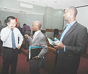 ICT Minister Ignace Gatare talking to the country manager of Huawei, Bai Kai as the Managing Director of Rock Global consulting Patrick Kabagema looks on. (Photo; F. Goodman)