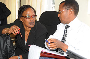 Ministry of Healthu2019s official  in charge of Mental Health, Yvonne Kayiteshonga chatting with CLNGu2019s Deogene Bideri during a meeting on managing Trauma yesterday. (Photo; J. Mbanda).