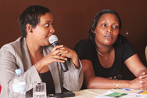 Nyanja Nzabamwita, founder and President of Ishami while making a point at the official launch as another participant looks on.