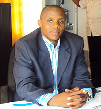 Du00e9siru00e9 Kayiru, Rwamagana branch manager in his office, behind is the station technician Bertin Nzeyimana. (Photo: S. Rwembeho)